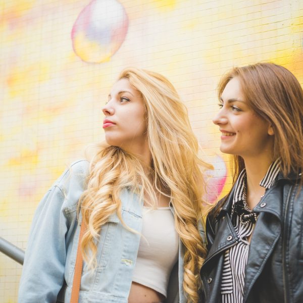 two-beautiful-blonde-and-brunette-girl-having-fun-in-the-city.jpg